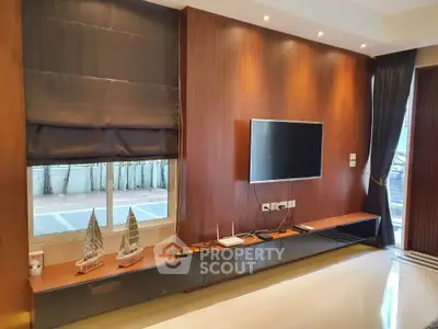 Modern living room with sleek wooden paneling and mounted TV