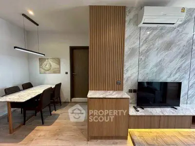 Modern living room with stylish dining area and sleek marble accents