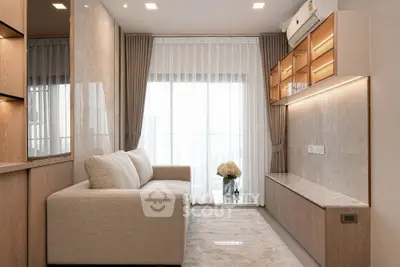 Modern living room with elegant beige sofa, floor-to-ceiling windows, and stylish built-in cabinetry.