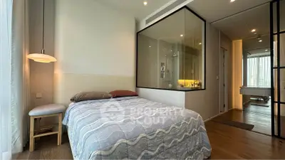Modern bedroom with glass-enclosed shower and cozy decor