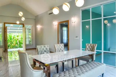 Luxurious modern dining room with elegant lighting and stylish furniture in a spacious open layout.