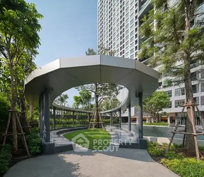 Modern high-rise building with landscaped garden and unique architectural design.