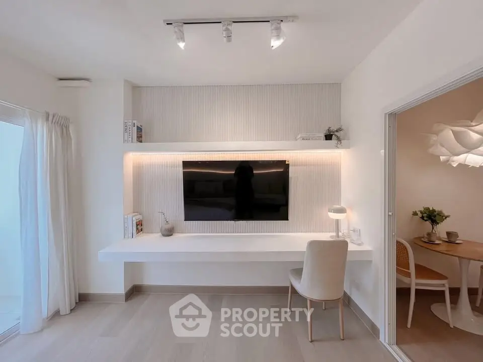 Modern living room with sleek TV setup and cozy dining area