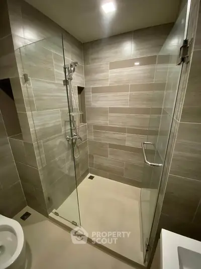 Modern bathroom with glass shower enclosure and sleek tile design
