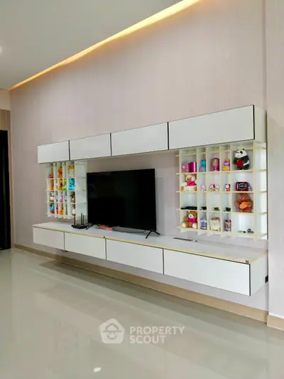 Modern living room with sleek wall-mounted TV unit and decorative shelves
