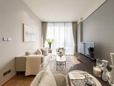 Elegant modern living room with stylish decor and large windows offering natural light.