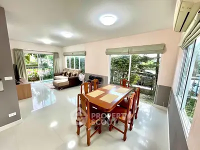 Spacious living room with garden view and elegant dining area