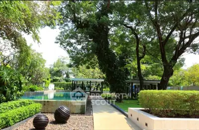 Luxurious garden with pool and modern outdoor amenities in serene setting.
