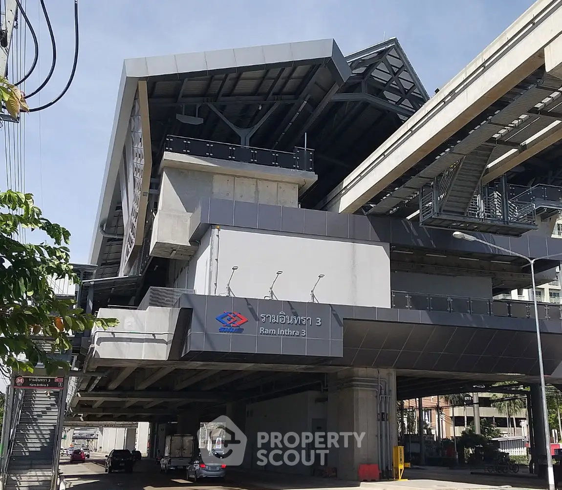 Modern urban transit station with sleek architectural design and elevated tracks.
