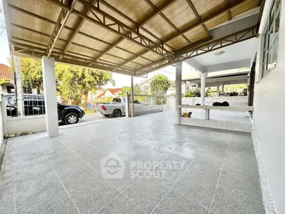Spacious covered parking area with tiled flooring and open view