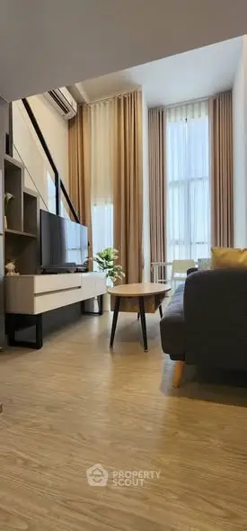 Modern living room with high ceilings and stylish furniture