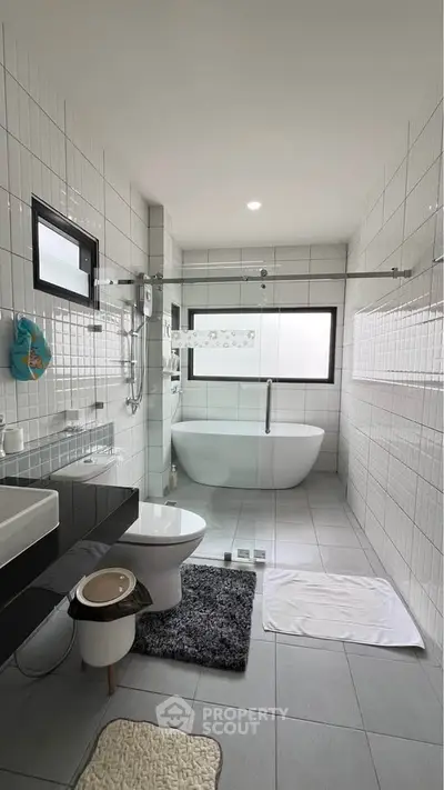 Modern bathroom with freestanding tub and glass shower enclosure