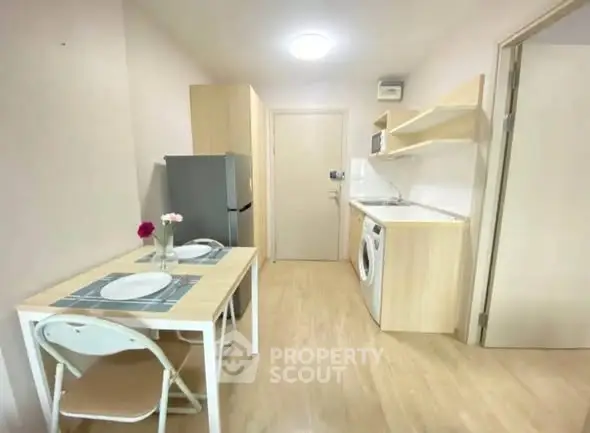 Cozy kitchen with dining area, featuring modern appliances and light wood finishes.