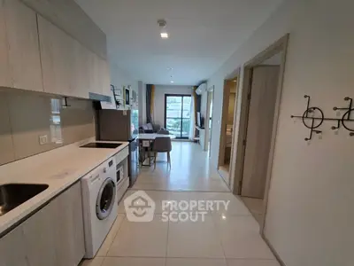 Modern open-plan kitchen and living area with sleek appliances and stylish decor.