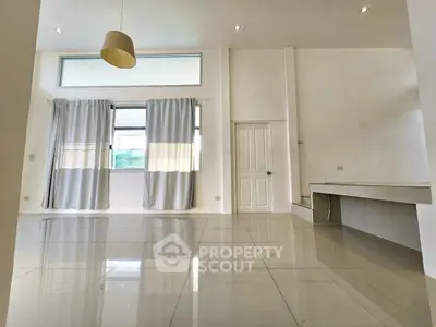 Spacious modern living room with high ceilings and large windows