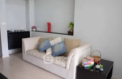 Cozy living room with modern sofa and stylish decor, perfect for relaxation and entertaining guests.