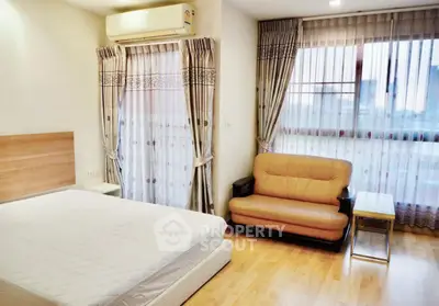 Spacious bedroom with modern decor and natural light