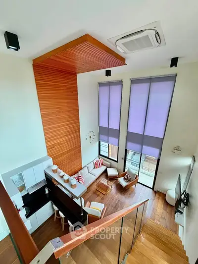 Stunning modern loft with high ceilings and open layout, featuring stylish kitchen and cozy living area.