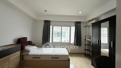 Spacious bedroom with modern furnishings and ample natural light.