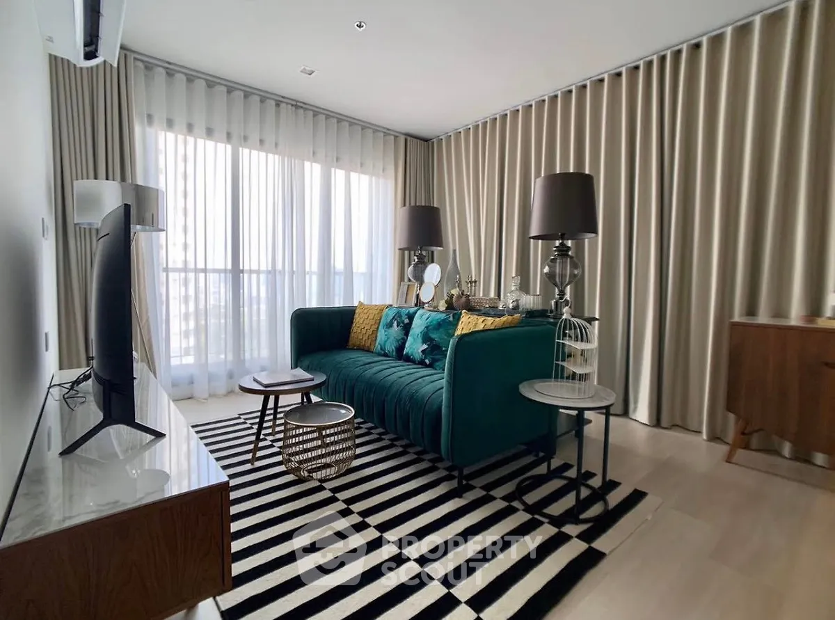 Stylish living room with modern decor and large windows in a luxury apartment.
