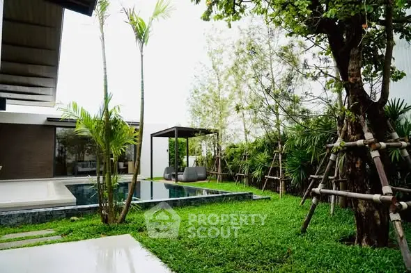 Luxurious modern garden with pool and lush greenery, perfect for relaxation and outdoor entertainment.