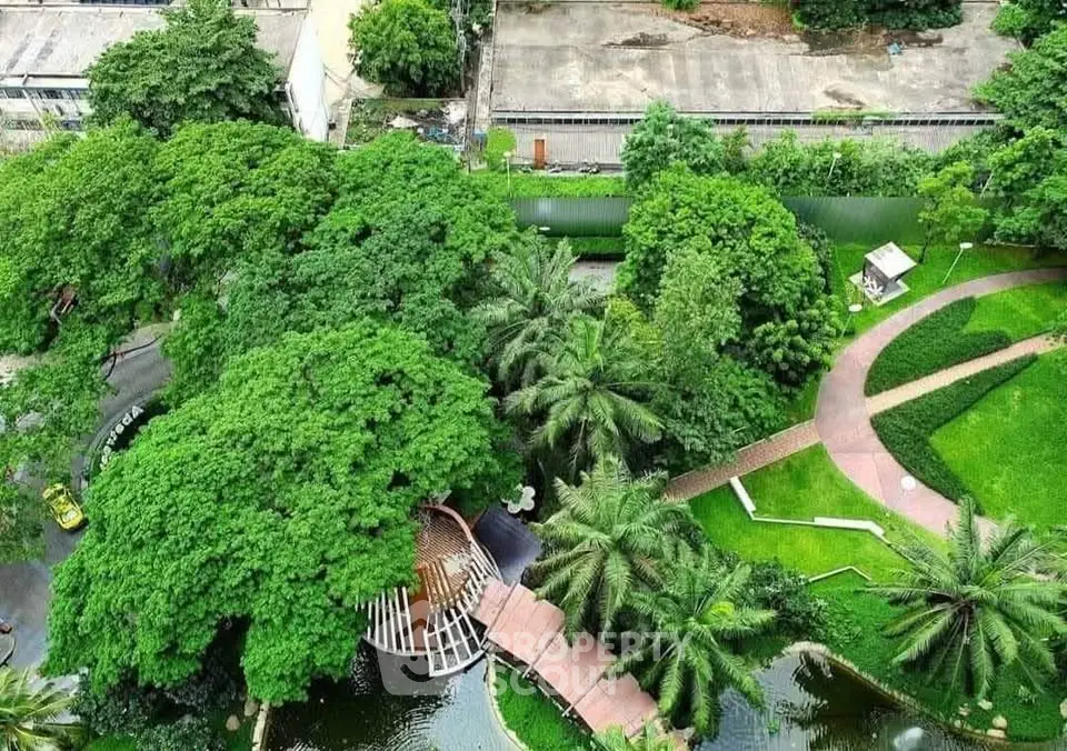 Lush green garden with pathways and water features in a serene residential complex.