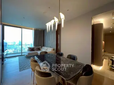 Luxurious open-plan living and dining area with city view, featuring elegant lighting and modern furnishings.