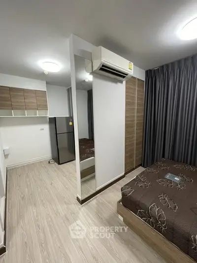 Modern bedroom with air conditioning and stylish decor in a cozy apartment.