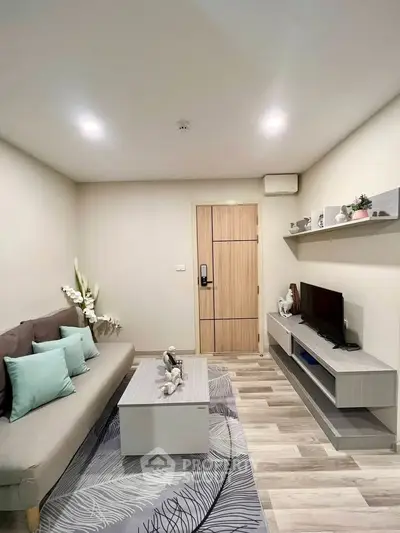 Modern living room with stylish decor and cozy ambiance, featuring a sleek sofa and entertainment unit.