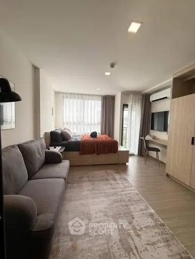 Modern studio apartment with cozy living area and stylish decor