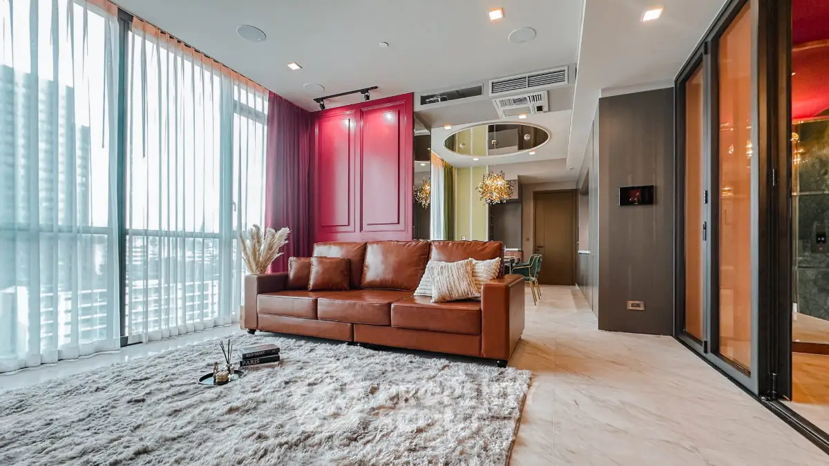 Luxurious modern living room with leather sofa and large windows in high-rise apartment