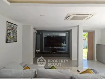 Spacious modern living room with sleek design and large TV setup