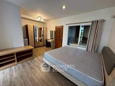 Spacious bedroom with modern furnishings and ample natural light