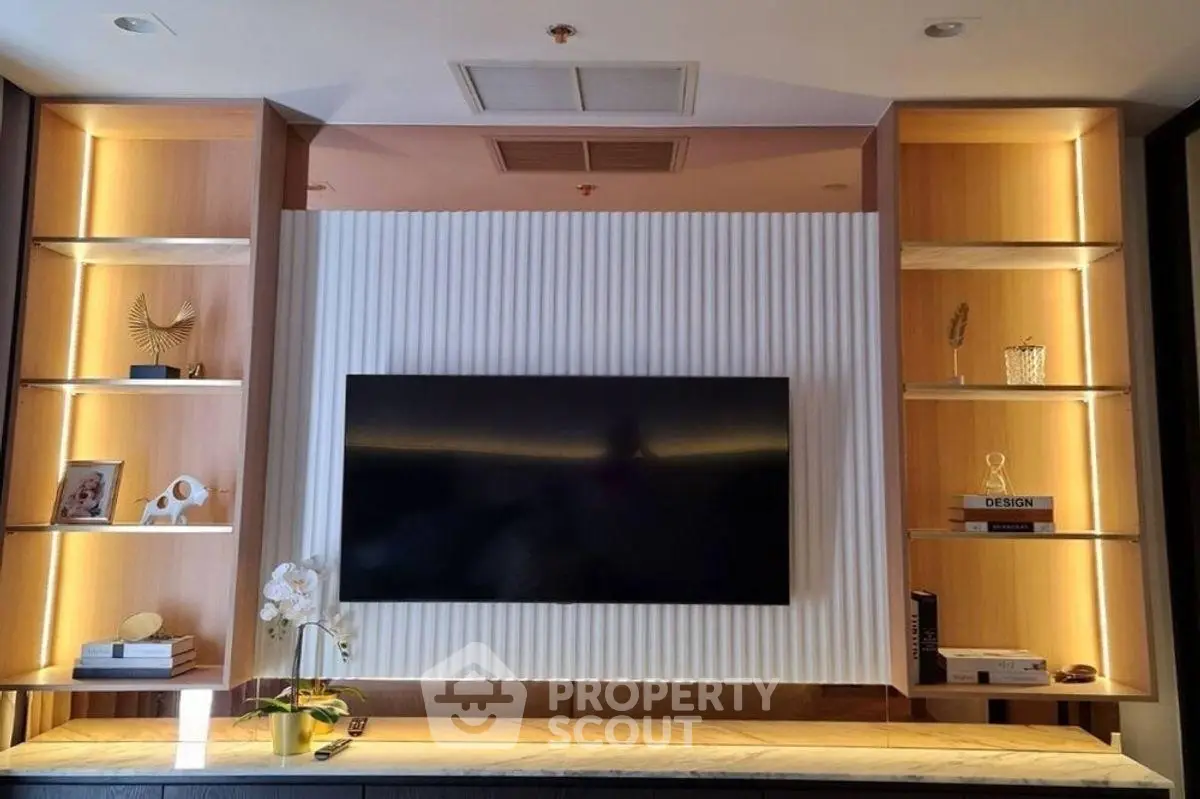 Modern living room with stylish TV setup and elegant shelving