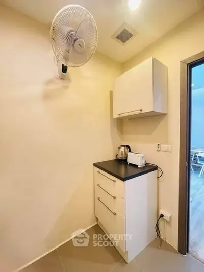 Compact kitchen corner with modern cabinets and appliances