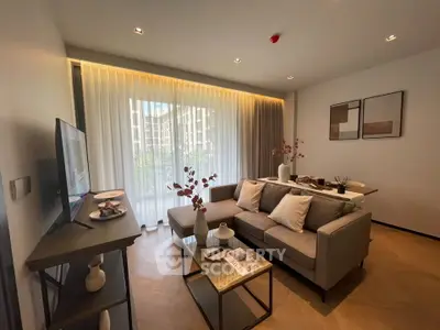 Modern living room with stylish decor and large window offering natural light