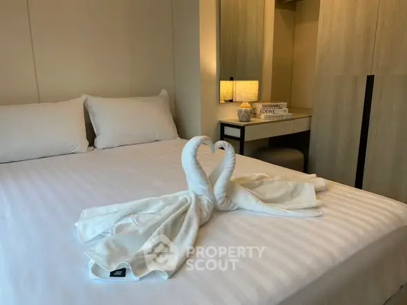 Elegant bedroom with stylish decor and cozy ambiance, featuring a neatly arranged bed and soft lighting.