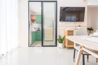 Modern open-plan living room with sleek kitchen and stylish decor