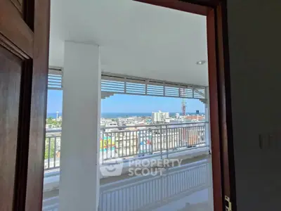 Spacious balcony with stunning city and ocean views, perfect for relaxation and entertainment.