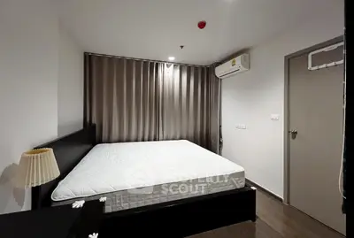 Modern bedroom with sleek design and air conditioning in a stylish apartment.