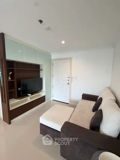 Modern living room with sleek furniture and built-in TV unit