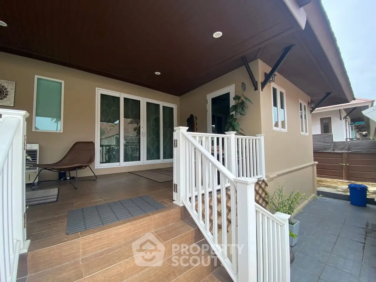 Charming residential entrance with modern design and cozy seating area.