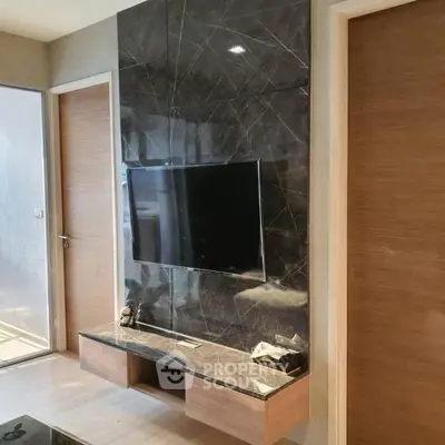 Modern living room with sleek TV wall unit and marble accents