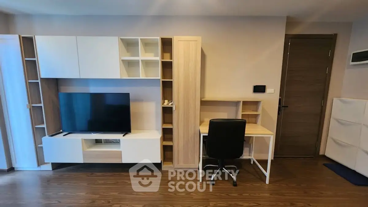 Modern living room with sleek TV unit and compact study desk, perfect for urban living.