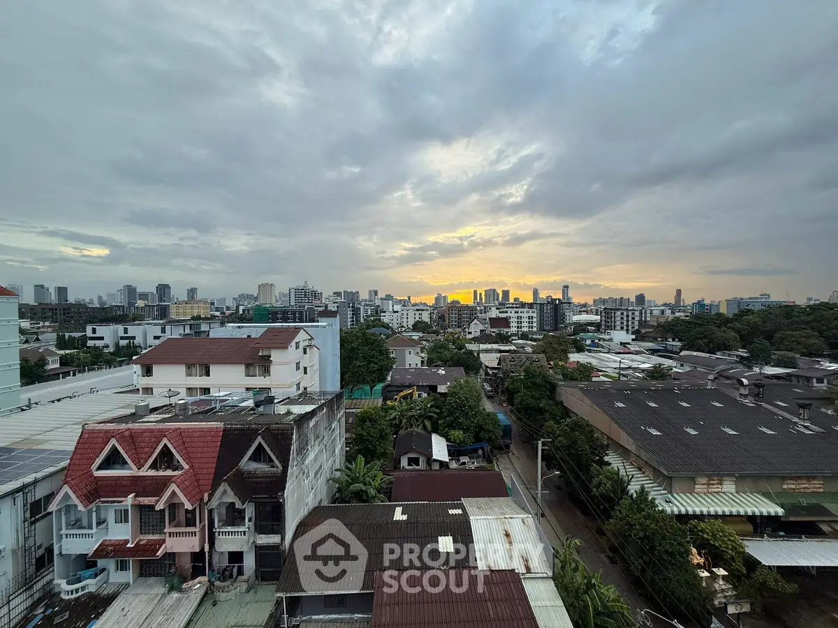 Stunning cityscape view at sunset with diverse architecture and lush greenery.