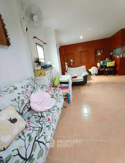 Spacious living room with stylish decor and comfortable seating in a cozy home.