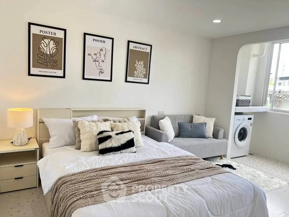 Modern bedroom with cozy decor and in-room washing machine