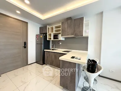 Modern kitchen with sleek cabinetry and stylish breakfast bar in a contemporary apartment.