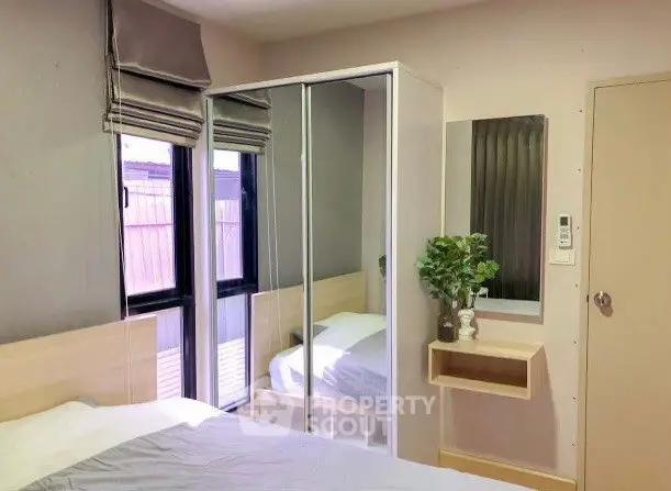 Cozy bedroom with mirrored wardrobe and modern decor