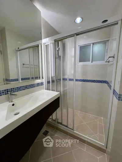 Modern bathroom with sleek shower enclosure and stylish sink